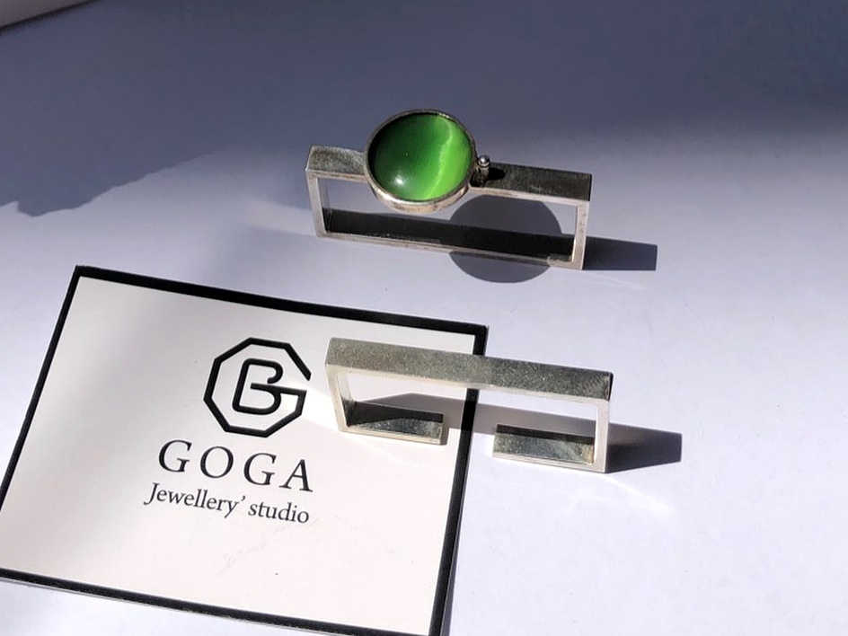 Geometric silver jewelry with green stone from prior studio work