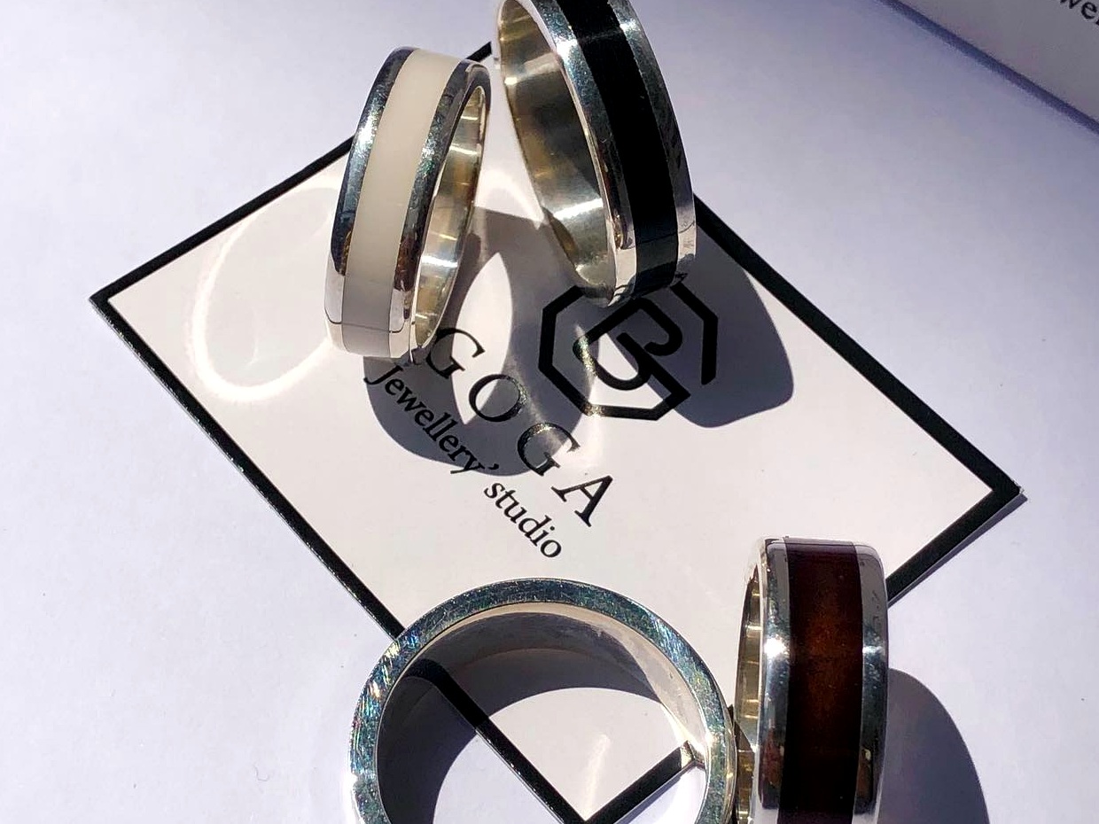 Finished silver rings with contrasting inlays from prior studio work