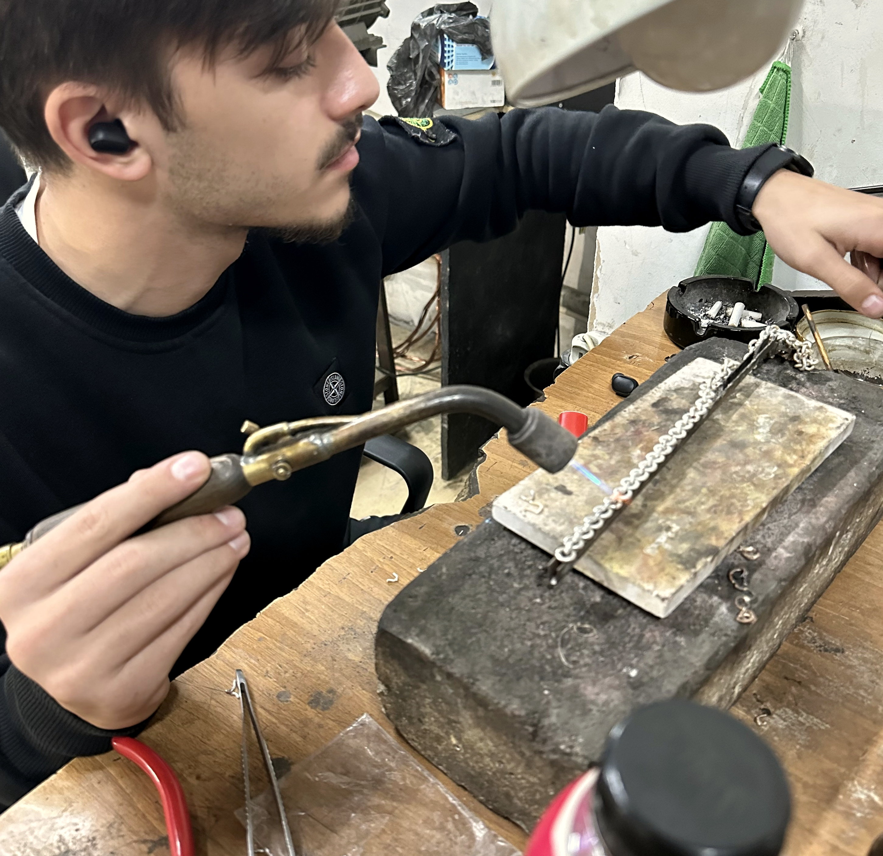 Jeweler working on a small jewelry production task